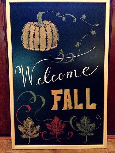 a welcome sign with fall leaves and pumpkins painted on the side of it ...