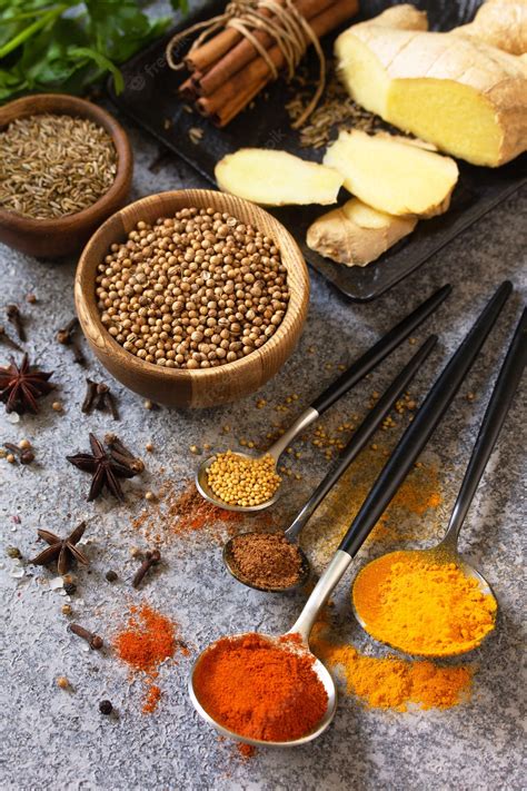 Premium Photo | Various of indian herbs and spices for cooking on a stone table