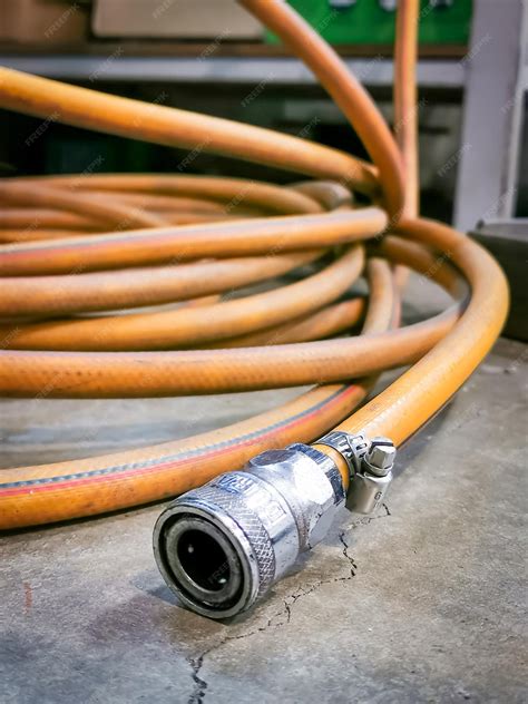 Premium Photo | Image of compressor coupler with yellow hose.