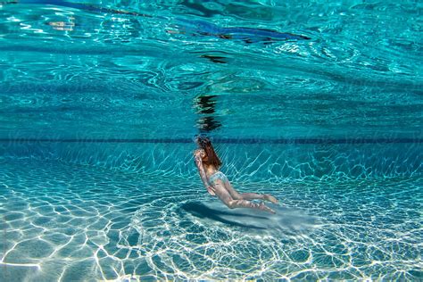 "Teenage Girl Floating Underwater In A Large Deep Blue Swimming Pool" by Stocksy Contributor ...