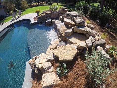 Natural Stone Outdoor Living Area | Stone pool, Pool waterfall, Landscape contractor