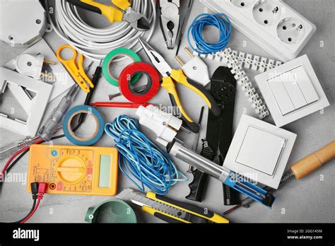 Electrician tools on grey background Stock Photo - Alamy