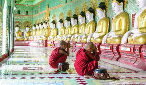 Asian Buddhist monks praying in temple, Mingun, Saigang, Myanmar - Stock Photo - Dissolve