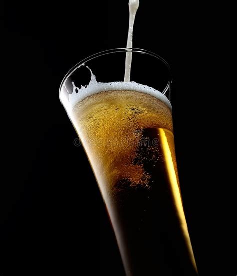 Beer is Pouring into Glass on Black Stock Image - Image of beverage, foam: 90732025