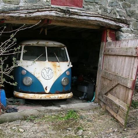 an old vw bus is parked in the garage