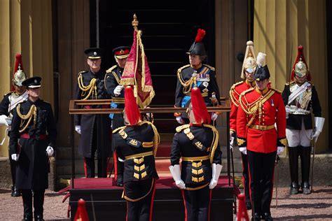 Charles presents flag to mounted cavalry ahead of first birthday parade