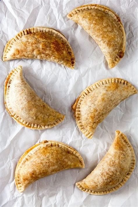 Tender-crisp empanada shells are stuffed with homemade apple pie filling and sweetened cream ...