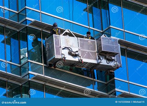 Professional High Rise Window Cleaning Service Workers Use Specialized Equipment To Access and ...