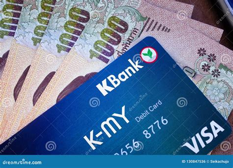 BANGKOK, THAILAND - NOVEMBER 16, 2018 - Kasikorn Bank Debit Card on Top of Thai Baht Paper Bills ...