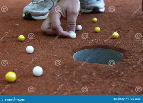 A Marble Player Shooting Marbles To the Hole Stock Image - Image of shoot, entertainment: 59482717