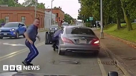 Moment police officer dragged away by escaping car – NewBabylon News