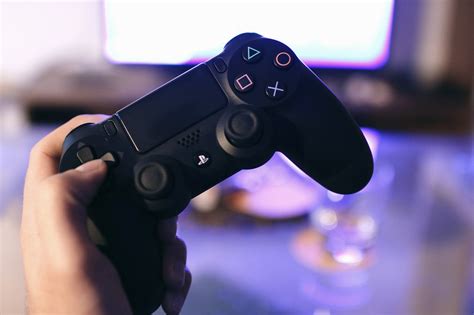 person holding sony ps4 game controller free image | Peakpx