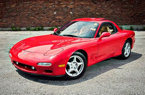 a red sports car parked in a parking lot