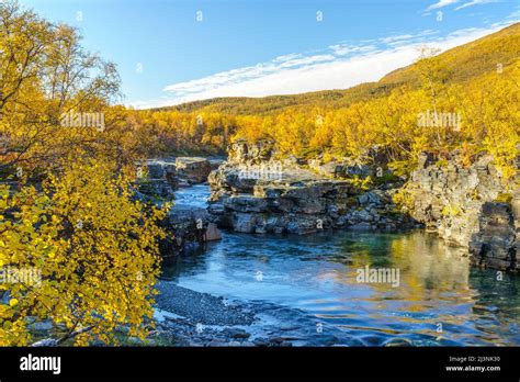 Abisko river in autumn season with autumn colors and blue sky, Abisko ...