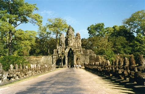 the entrance to an ancient temple surrounded by trees