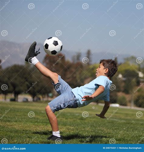 Boy Kicking Soccer Ball Stock Image - Image: 24075431