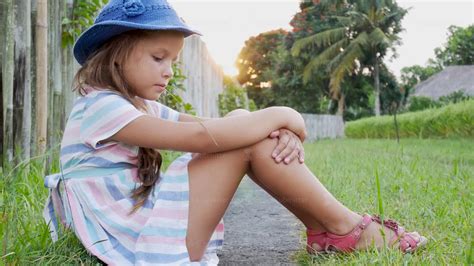 Happy little girl sitting on the grass and playing in summer garden. Outdoors. Sunset - YouTube