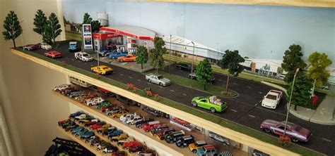 toy cars are lined up on the shelves in front of a gas station display case