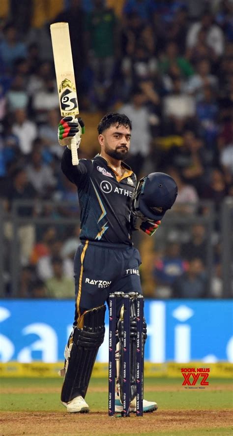 Mumbai : GT's Rashid Khan celebrates his half - century during the IPL ...