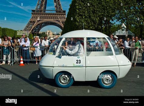 Funny looking electric car participating in Michelin Challenge Bibendum 2006 in front of Eiffel ...