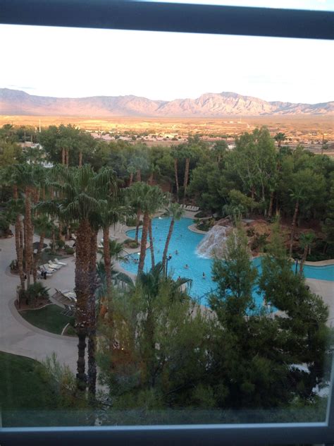 an aerial view of a pool surrounded by palm trees and mountains in the ...