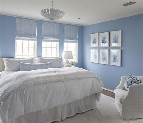 White and blue cottage bedroom boasts walls painted cornflower blue fitted with windows dressed ...