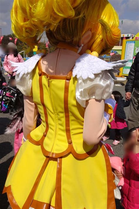 a woman dressed in yellow and white is standing next to other people at ...