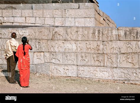 Indian couple contemplating the wall carvings. Mahanavami Dibba. Royal enclosure. Hampi. India ...