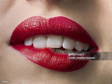 Female With Red Lipstick Biting Lips Close Up High-Res Stock Photo ...