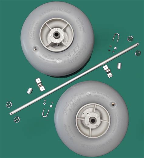 two white wheels and some metal parts on a blue background