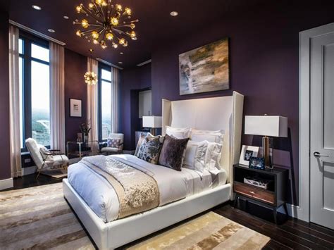 Majestic plum walls and a decadent ivory headboard give the master ...