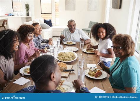 Three Generation African American Family Sitting at the Table Talking ...