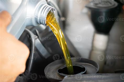 Pouring engine oil to car engine. Fresh oil poured during an oil change ...