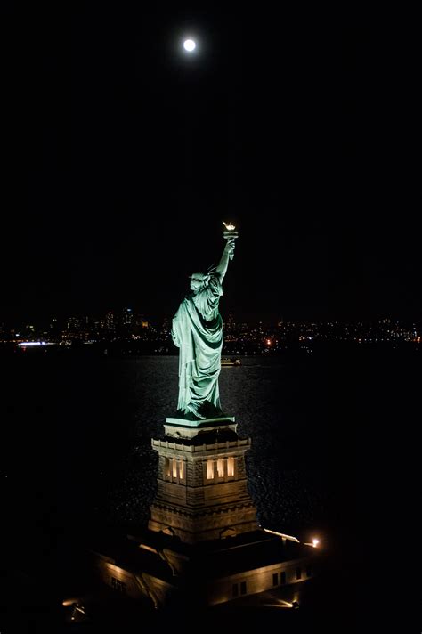 Check out these breathtaking nighttime photos of the Statue of Liberty