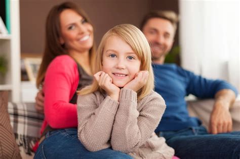 Free Photo | Smiling little girl with parents at home