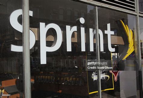 The Sprint Nextel logo hangs in the window of a Sprint retail store... News Photo - Getty Images