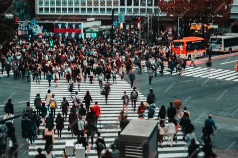 Premium Photo | A busy street with people walking and a sign that says shibuya on it