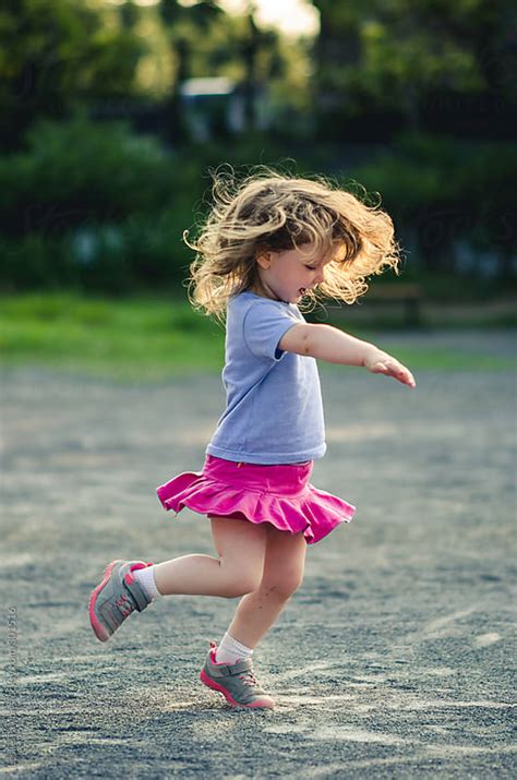 Little Girl Spinning Around And Dancing by Leslie Taylor - Stocksy United