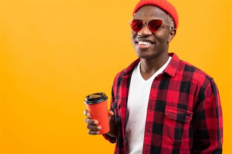 Premium Photo | Stylish black american man in checkered red shirt with glass of coffee on yellow