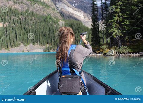 Canoeing in Moraine Lake stock image. Image of river - 136909293