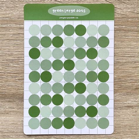 a green and white polka dot sticker on top of a wooden table