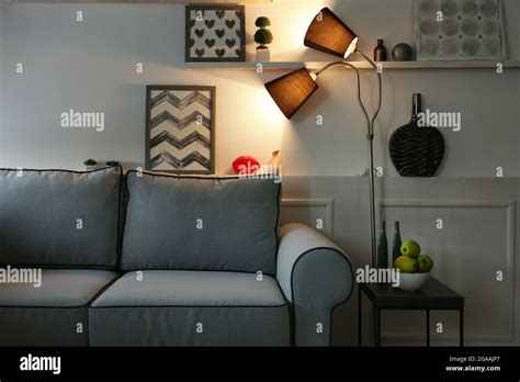 Beautiful modern living room with grey sofa and floor lamp Stock Photo - Alamy