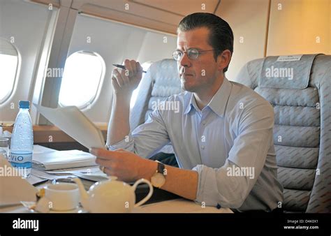 German Economy Minister Karl-Theodor zu Guttenberg studies files onboard German air force Airbus ...