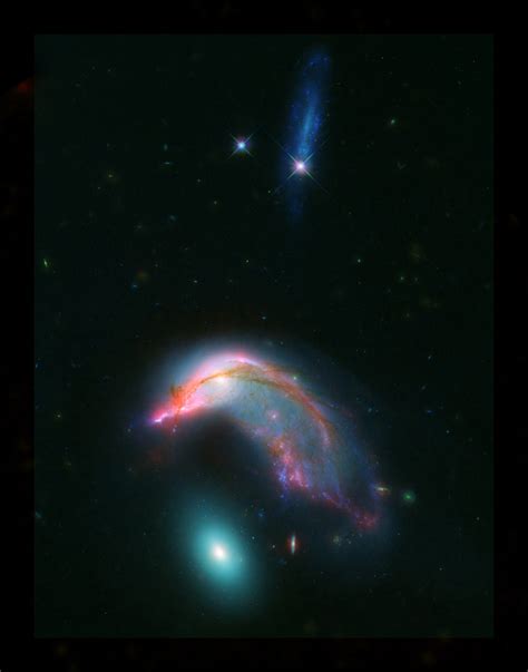 'Penguin guarding its egg': Hubble captures distant colliding galaxies in a breathtaking cosmic shot