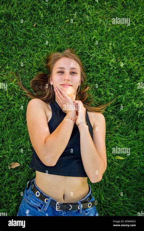 Young Woman Laying on Grass On University Campus Stock Photo - Alamy