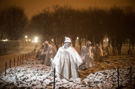 Snow falls on the sculptures at the Korean War Veterans Memorial. Korean War Veterans Memorial ...