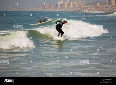 Surfing waves of Far Rockaway Beach on a very hot day of June Far Rockaway Beach Queens New York ...