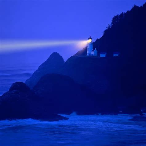 Lighthouse beams across stormy night sea - Heceta Head, Oregon Coast ...