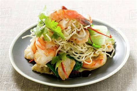 Bami Goreng with shrimps and chicken (Indonesia) - Stock Photo - Dissolve