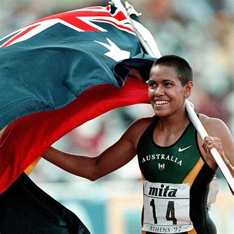 1997 _ Cathy Freeman waves both the Australian and Aboriginal flags at ...